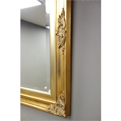  Rectangular bevelled edged mirror in swept gilt frame, 80cm x 138cm  