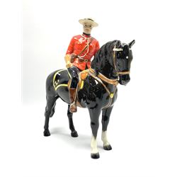 A model of a Canadian Mountie on horseback, probably Beswick, unmarked, H21.5cm. 