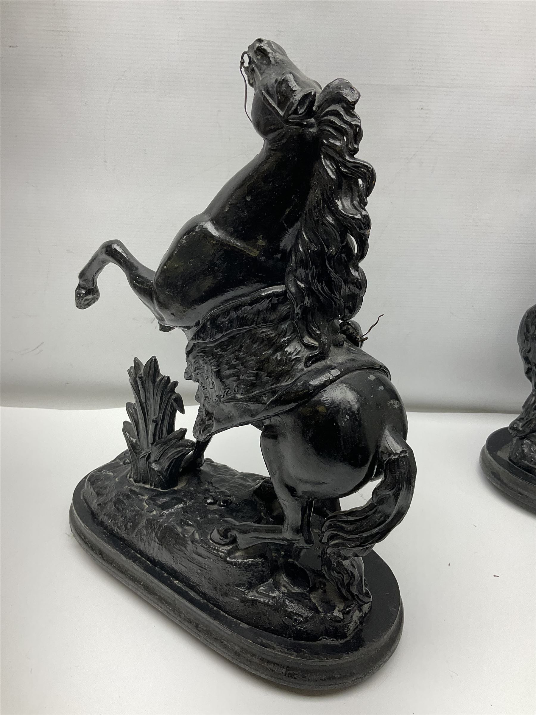 Pair of spelter figural statues of man and rearing horse, height 44cm and 42cm