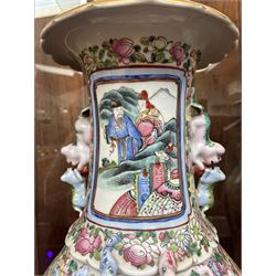 Large pair of 19th century Cantonese famille rose vases, each painted with various courtly scenes, including a display of warriors fighting on horseback before an official and his attendants, double Buddhist lion handles and applied at the shoulders with chilong, the lower band painted with Greek key motif, H58cm (2)