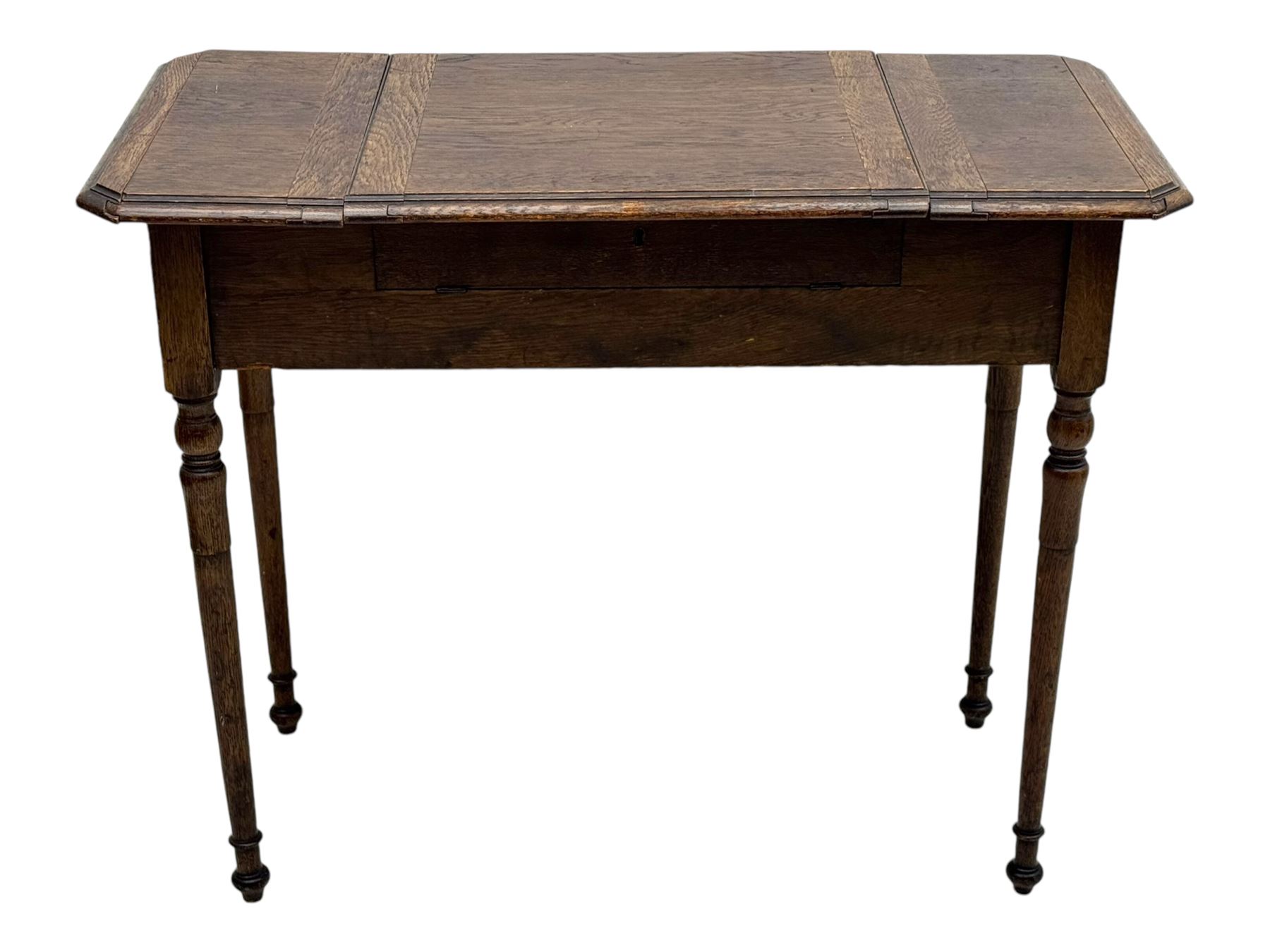 Edwardian oak metamorphic 'Britisher Writing Table', rectangular hinged top revealing correspondence compartments and hinged writing surface with underside storage, flanked by twin hinged compartments with dividers, on turned supports