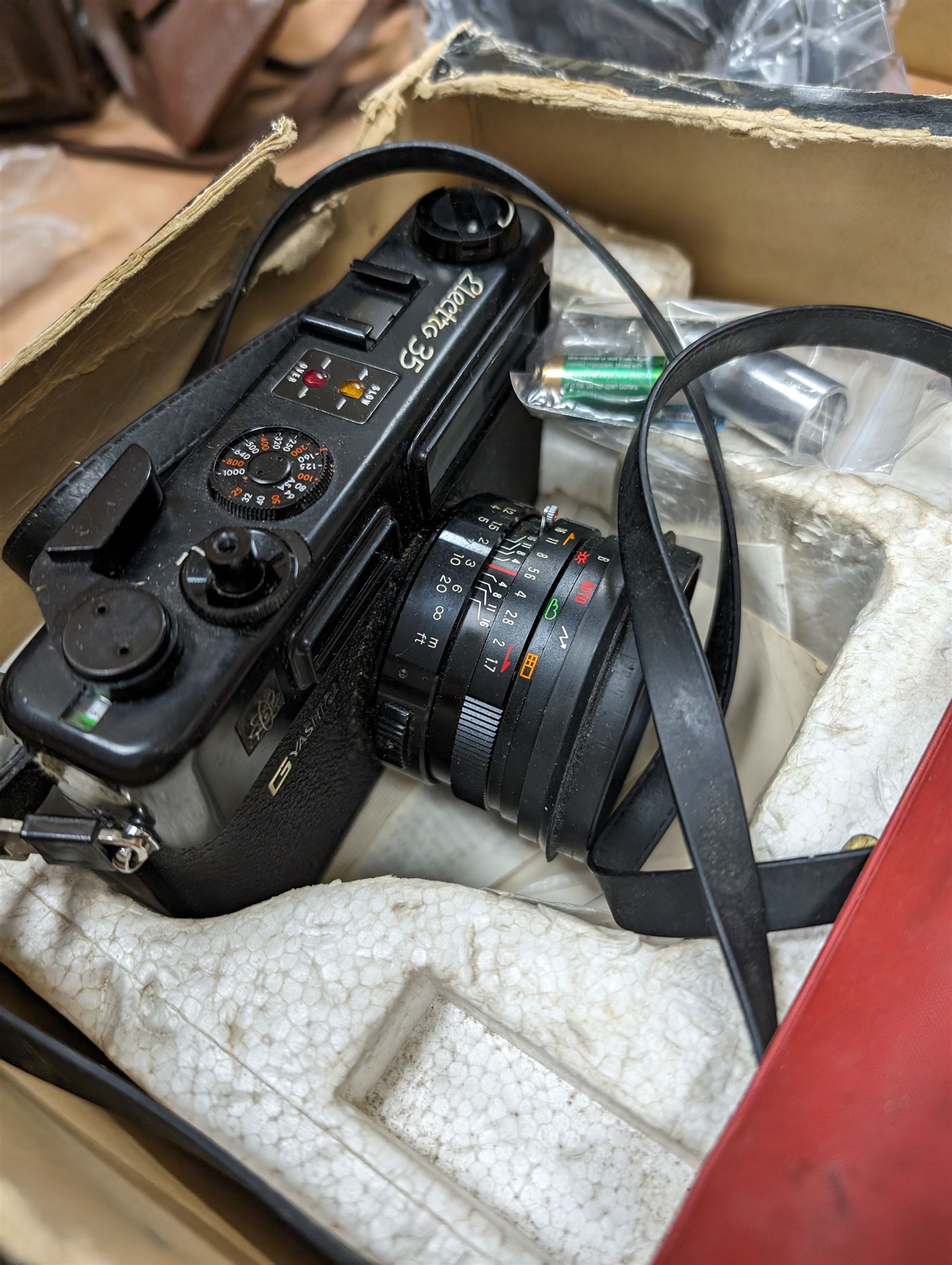 Yashica Electro 35mm film camera and a Kyocera Finecam SL400R, both boxed