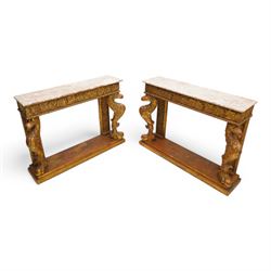 Pair of carved giltwood and composition console or pier tables, rectangular variegated rouge marble top, the frieze decorated with trailing vine and grape bunches, eagle front supports on stepped rectangular base