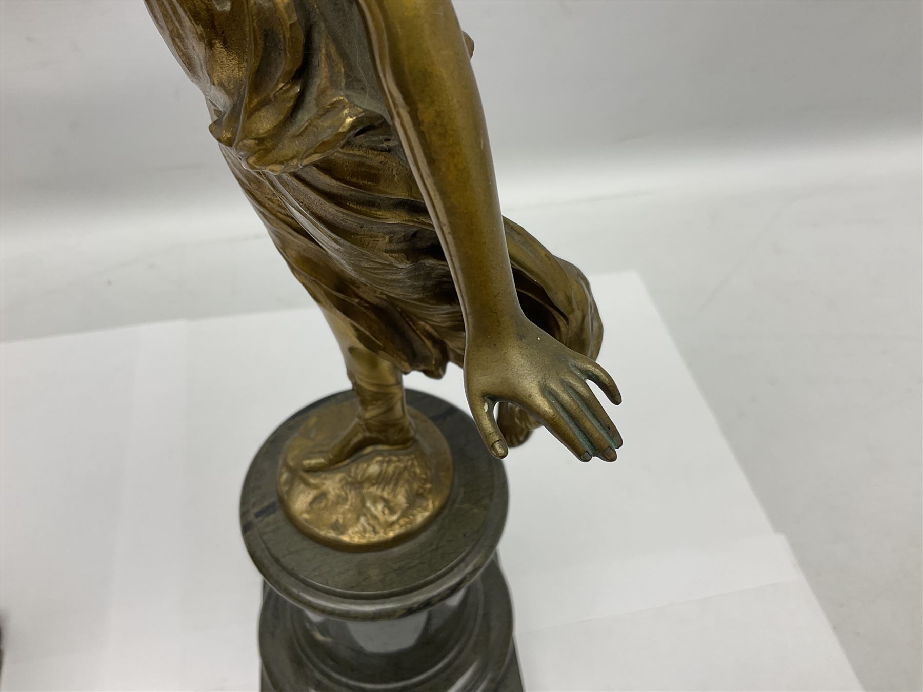 After Oswald Schimmelpfennig (German, 1872-1939): Pair of gilt bronze winged Allegorical female figures, the first example with arm outstretched holding a branch, signed 'Schimmelpfennig 1900', the second with arm raised above her head holding a book and sword in the other, both raised upon marble plinths, H45cm