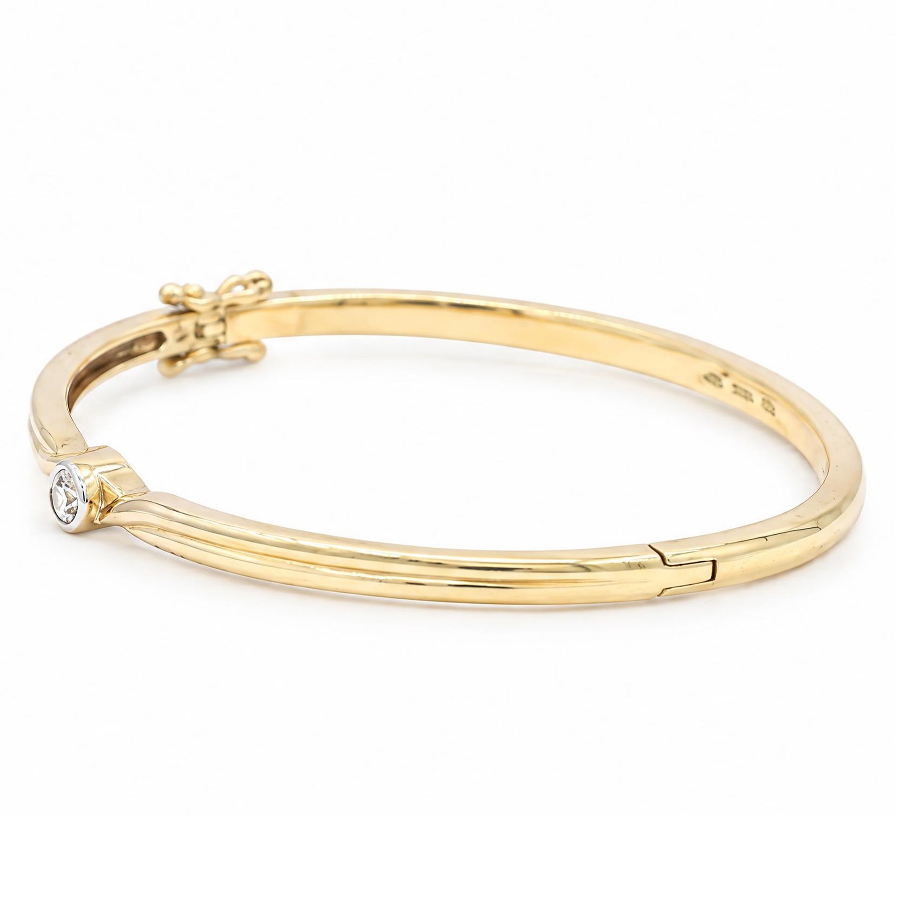 9ct gold diamond hinged bangle, set with a single round brilliant cit diamond, hallmarked