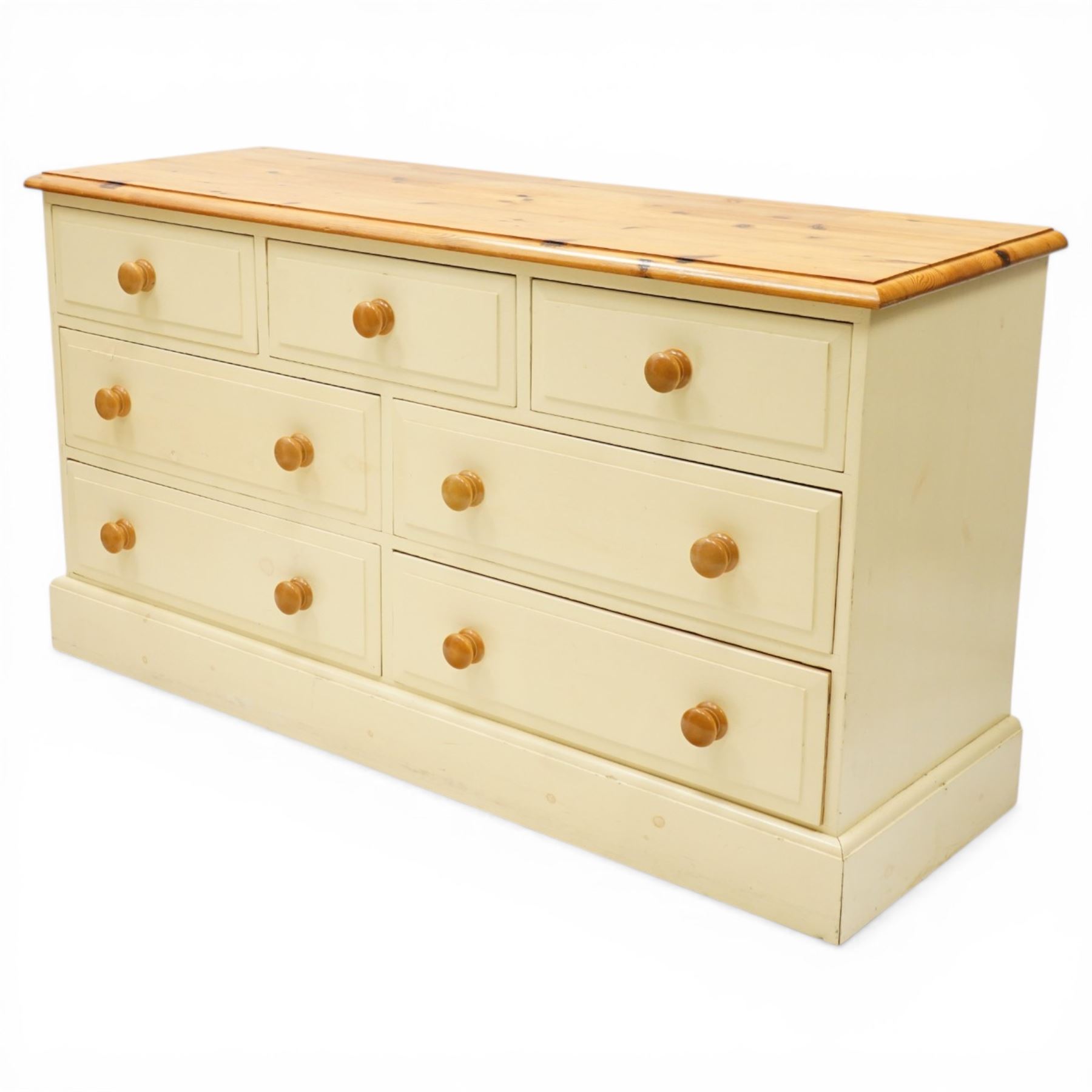 20th century painted pine chest, rectangular top over an assortment of seven drawers, on skirted base