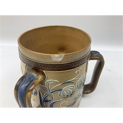 Mark V Marshall (1879-1912) for Doulton Lambeth stoneware tyg, decorated with stylised flowers  in blue upon a buff ground, with impressed marks beneath, H15cm