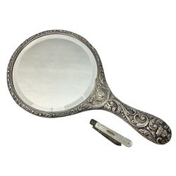 Silver mounted dressing table mirror, embossed with birds, masks, and foliate and C scrolls, hallmarked Birmingham, and fruit knife with mother of pearl handle and silver blade, (2)