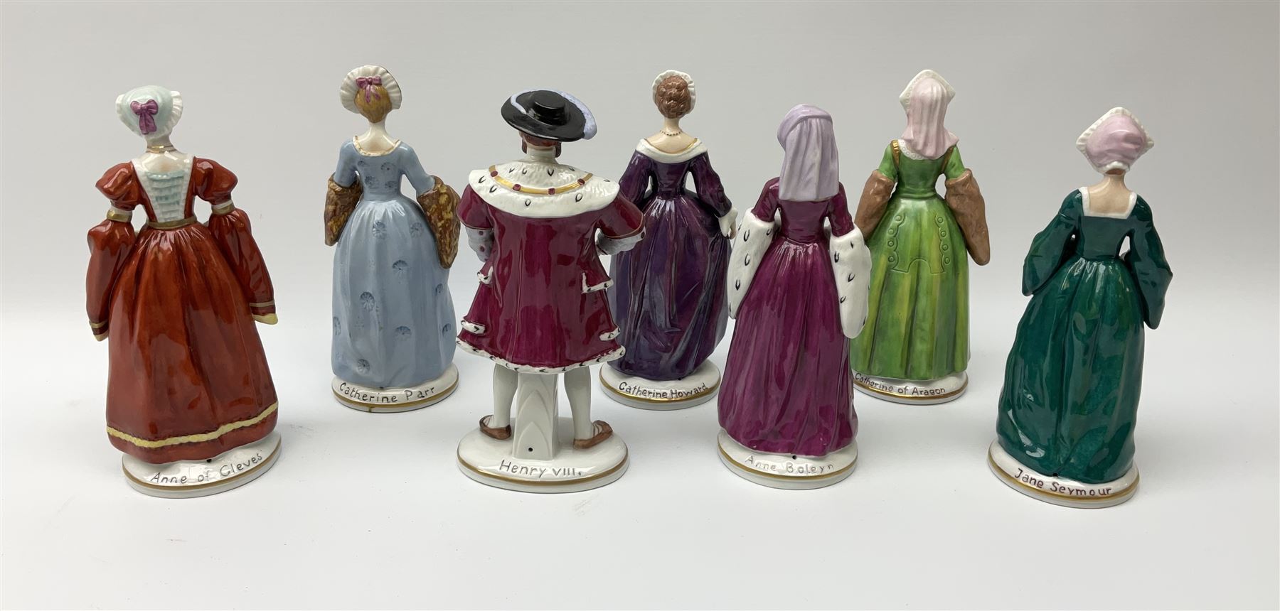 Sitzendorf Henry VIII & his wives porcelain figures, a set of 7 with impressed titles to the reverse, comprising of King Henry VIII, Anne Boleyn, Catherine of Aragon, Catherine Parr, Jane Seymour, Catherine Howard, Anne of Cleves.  