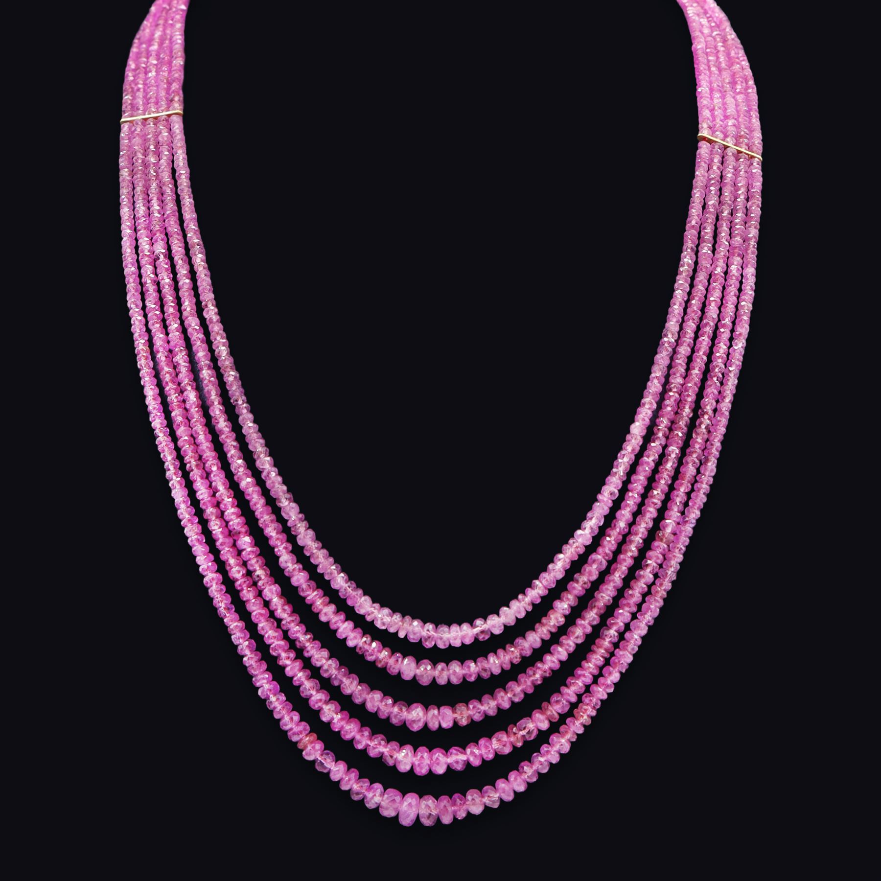 18ct gold pink sapphire necklace, five graduating stands of faceted pink sapphires, with an 18ct gold clasp, London 2004