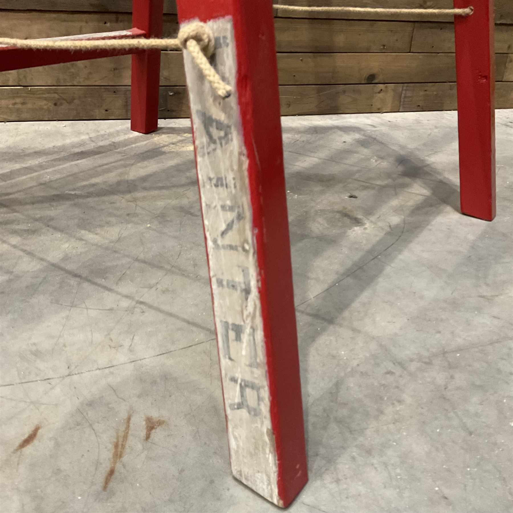 Pair of vintage red painted A frame trestles, with original A W Oates Painter signage