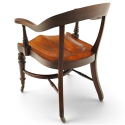 19th century carved mahogany Captain's desk chair, the bow-shaped cresting rail over curved back and turned arm supports, shaped saddle seat raised on turned supports united by crinoline stretcher, with brass cups and ceramic castors
