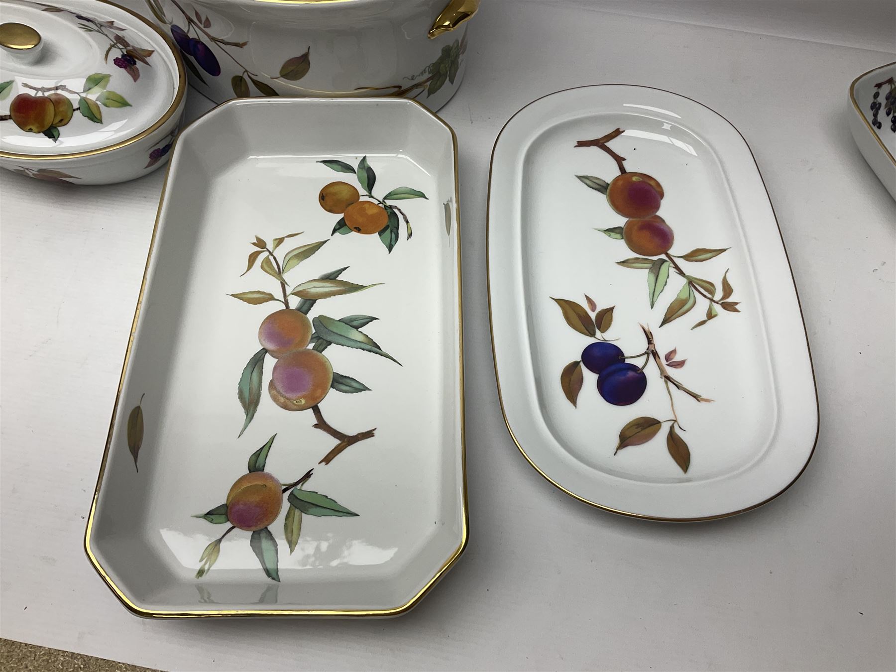 Royal Worcester Evesham pattern, including covered pot de cremes, twin handle tureen, serving dishes, flan dishes, side plates etc  