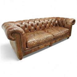 Timothy Oulton, Halo - late 20th century brown leather Chesterfield settee, the upholstered frame with deep buttoning to back and arms, large scroll terminals with brass studwork, twin seat cushions, raised on castored legs