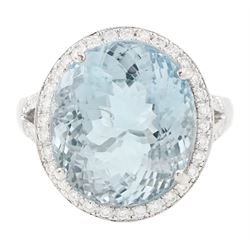 18ct white gold aquamarine and diamond cluster ring, single oval cut aquamarine of approx ...