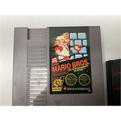 Nintendo Entertainment System (1985) console with two controllers, accessories and instruction booklet. NES Games ‘Duck Hunt’ with Nintendo Zapper gun, ‘Pinball’ and ‘Super Mario Bros.’, all with original sleeves and instruction booklets. NES game ‘Super Mario Bros. 2’ cartridge only