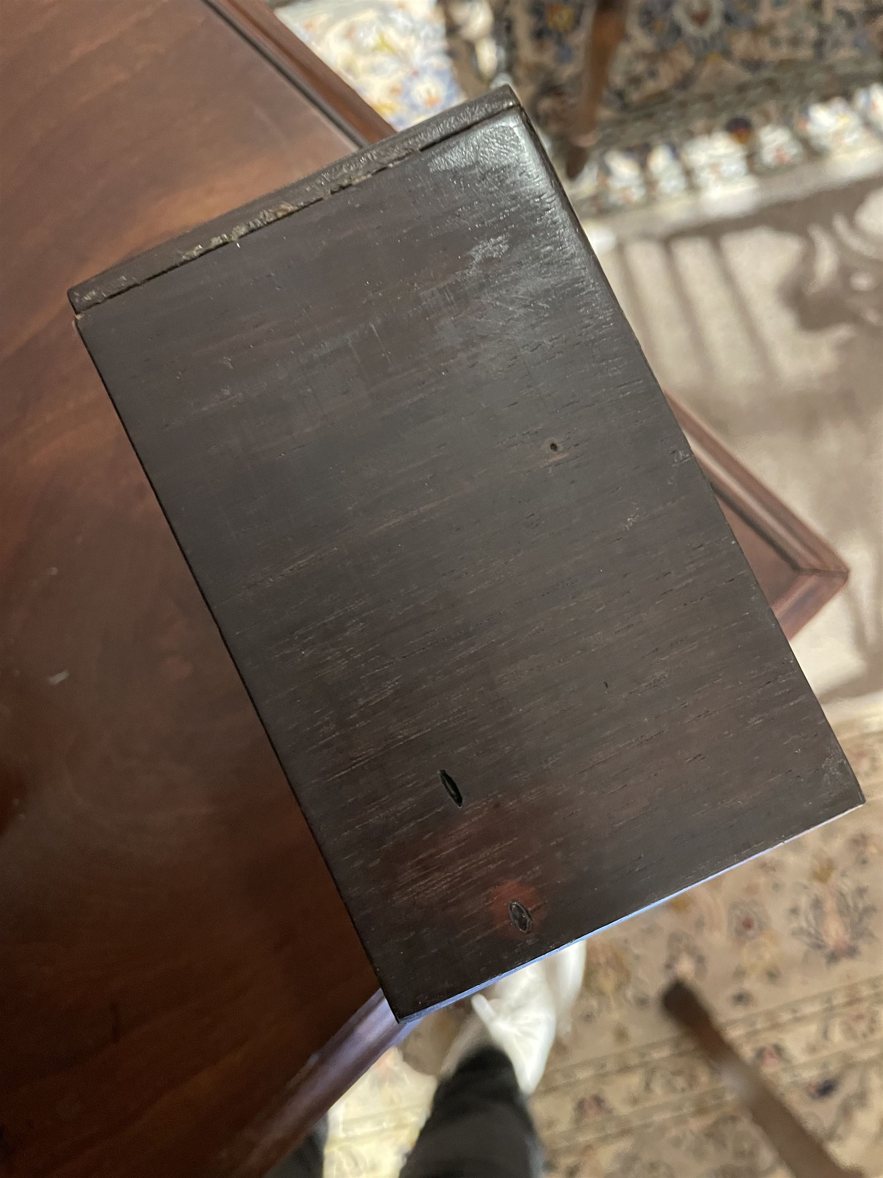 Early 19th century rosewood and brass inlaid tea caddy, of sarcophagus form, the front and hinged opening cover inlaid with brass scrolling panels, opening to reveal a compartmented interior with twin removable boxes with conforming inlaid brass detail to the hinged covers and zinc lining to the interiors, flanking a later glass mixing bowl, the whole upon four turned cylindrical feet, H21cm W36cm D20cm