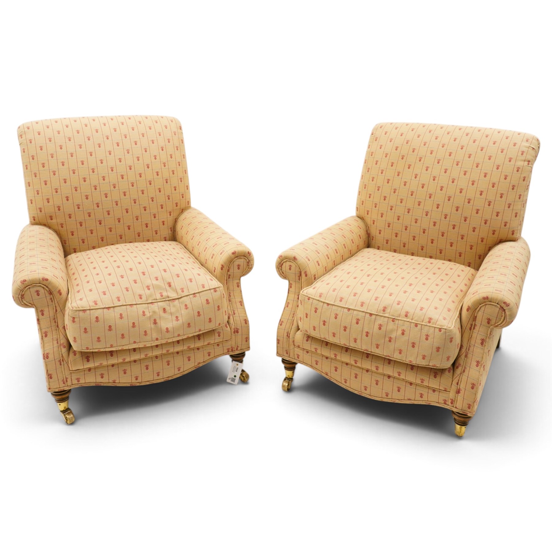 Pair of Victorian style armchairs of traditional shape, high rolled and sprung back over rolled arms, upholstered in chequered fabric with pineapple motifs with loose seat cushion, on turned feet with brass castors