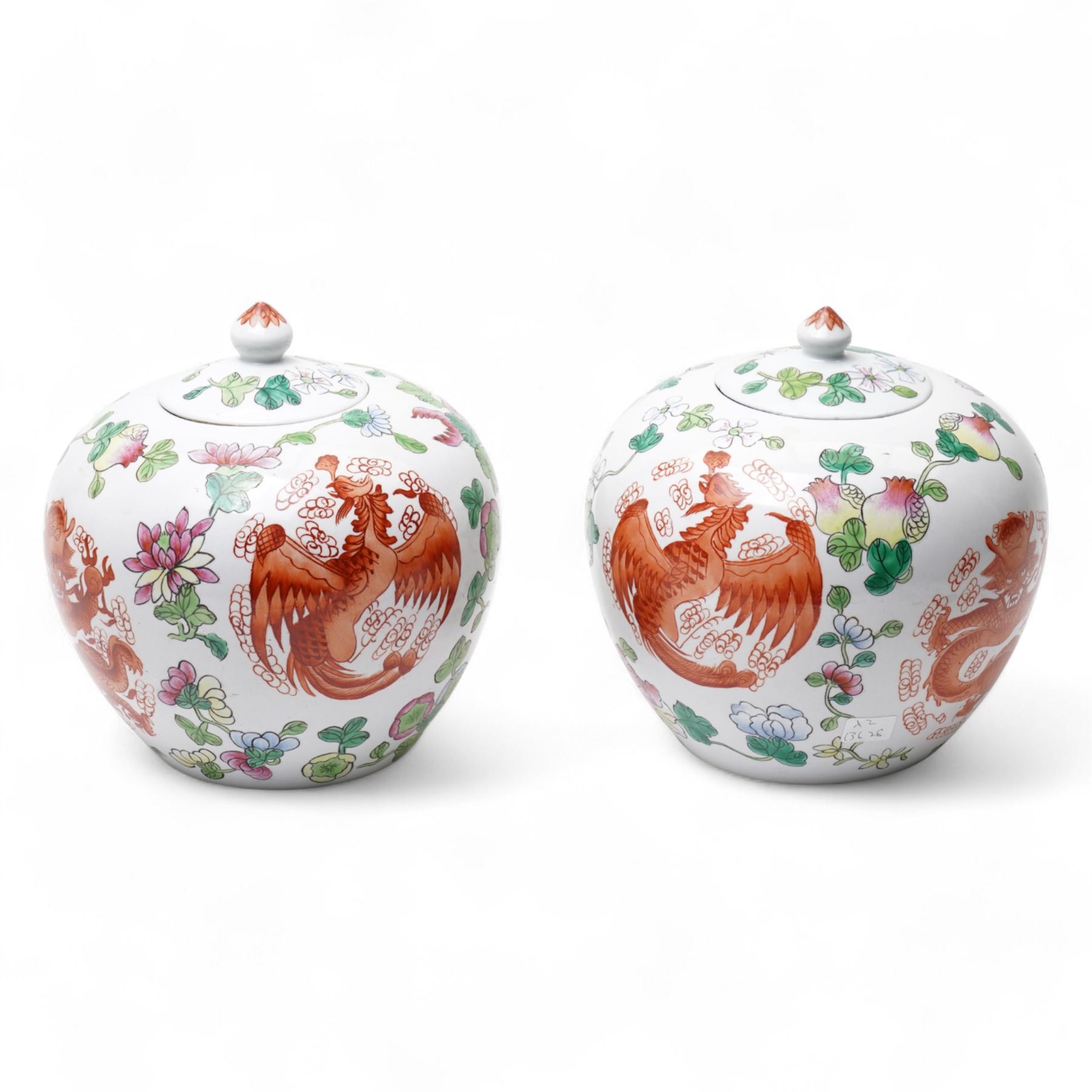 Pair of Chinese porcelain ginger jars and covers, painted with dragons and phoenix in iron red amidst flowering foliage, four character marks beneath, H20cm 