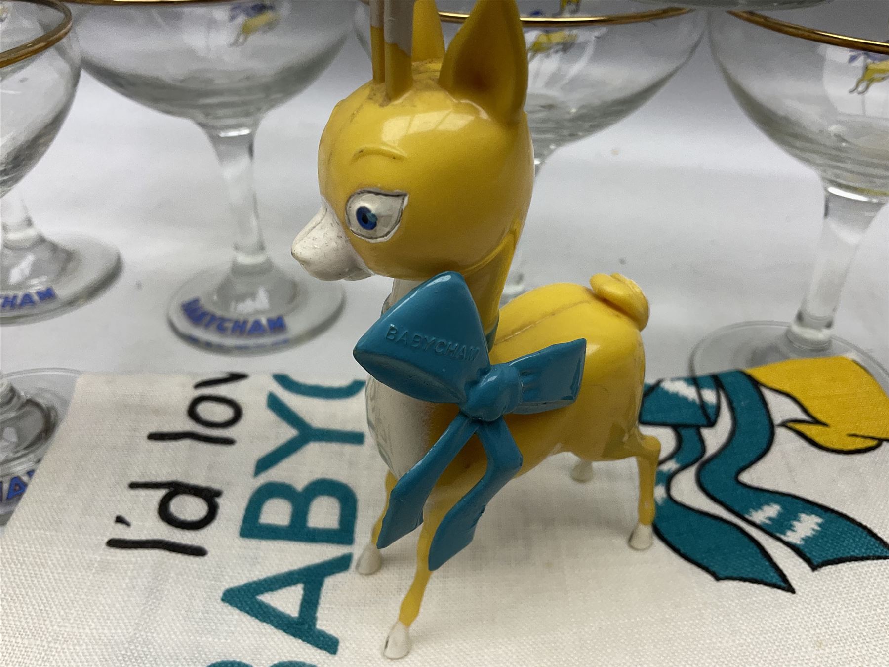 Breweriana; Eight Babycham glasses together with a Babycham plastic fawn mascot and linen I'd Love a Babycham tea towel