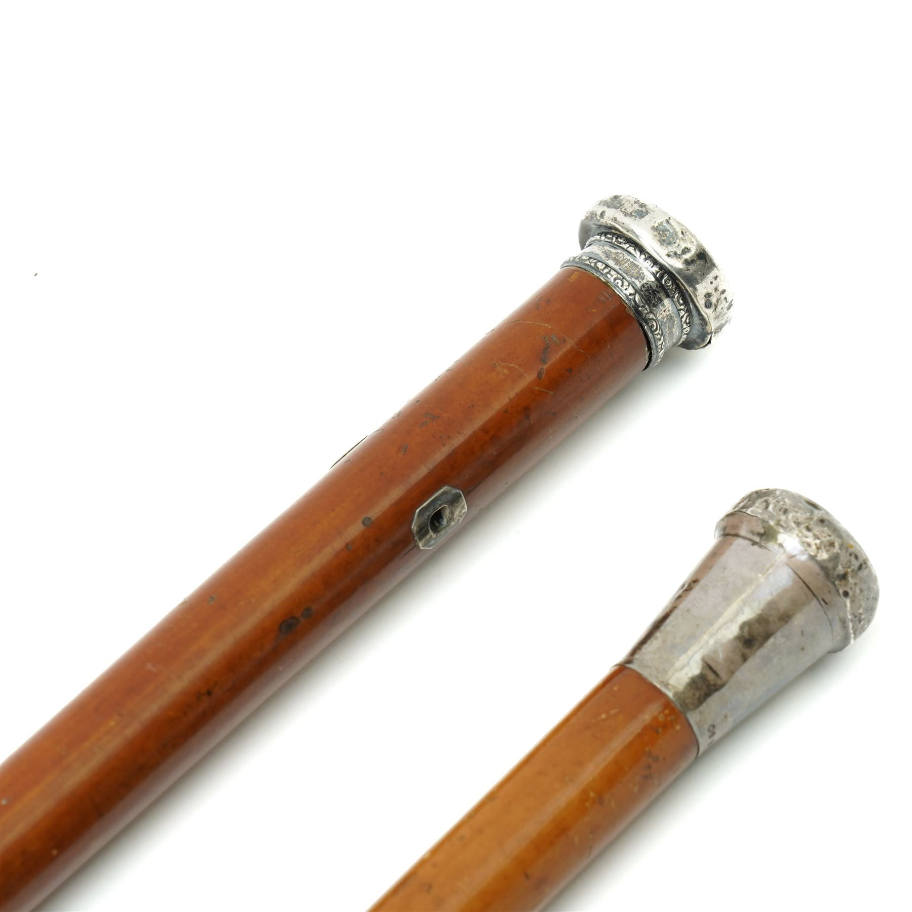 Malacca cane with silver top and the crest of Royal West Kent Regt and one other 19th century silver topped Malacca cane inscribed 'Lt. Doorne R.N.' (2)