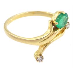Gold three stone oval cut emerald and round brilliant cut diamond ring