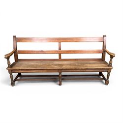Early 20th century pine and oak bench seat, stained pine rail back frame with shaped oak arms