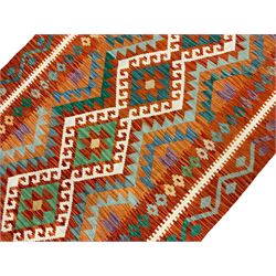 Anatolian Turkish Kilim amber ground rug, the field decorated with four lozenges with ivory outline, the double banded orange border with repeating geometric patterns 