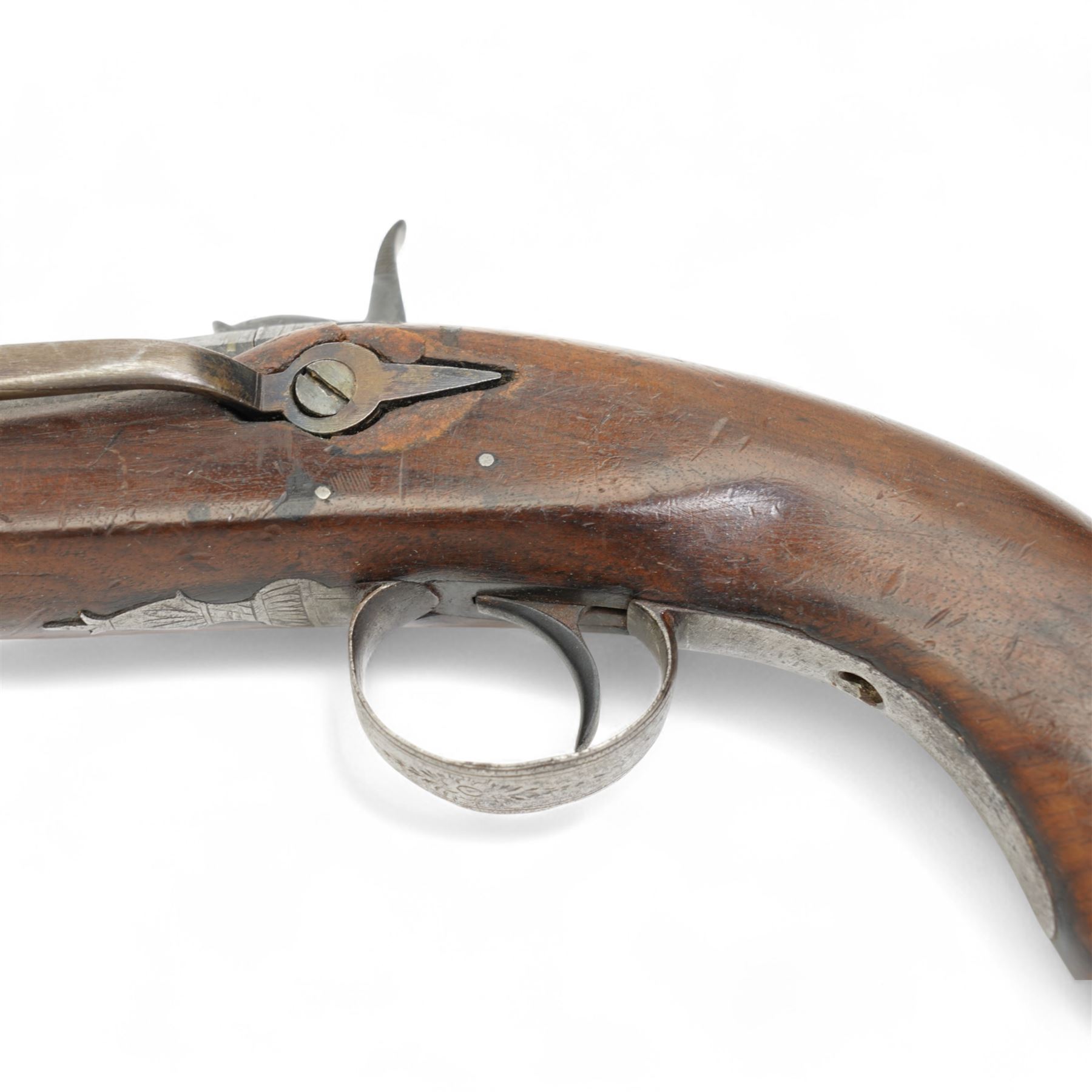 19th century percussion pistol with octagonal barrel, captive ramrod, belt hook, scroll engraved lock and trigger guard and walnut stock L25cm  