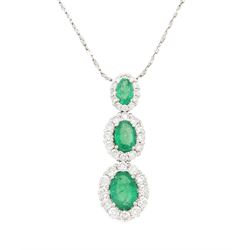 18ct white gold emerald and diamond cluster pendant, three graduating oval cut emeralds, e...