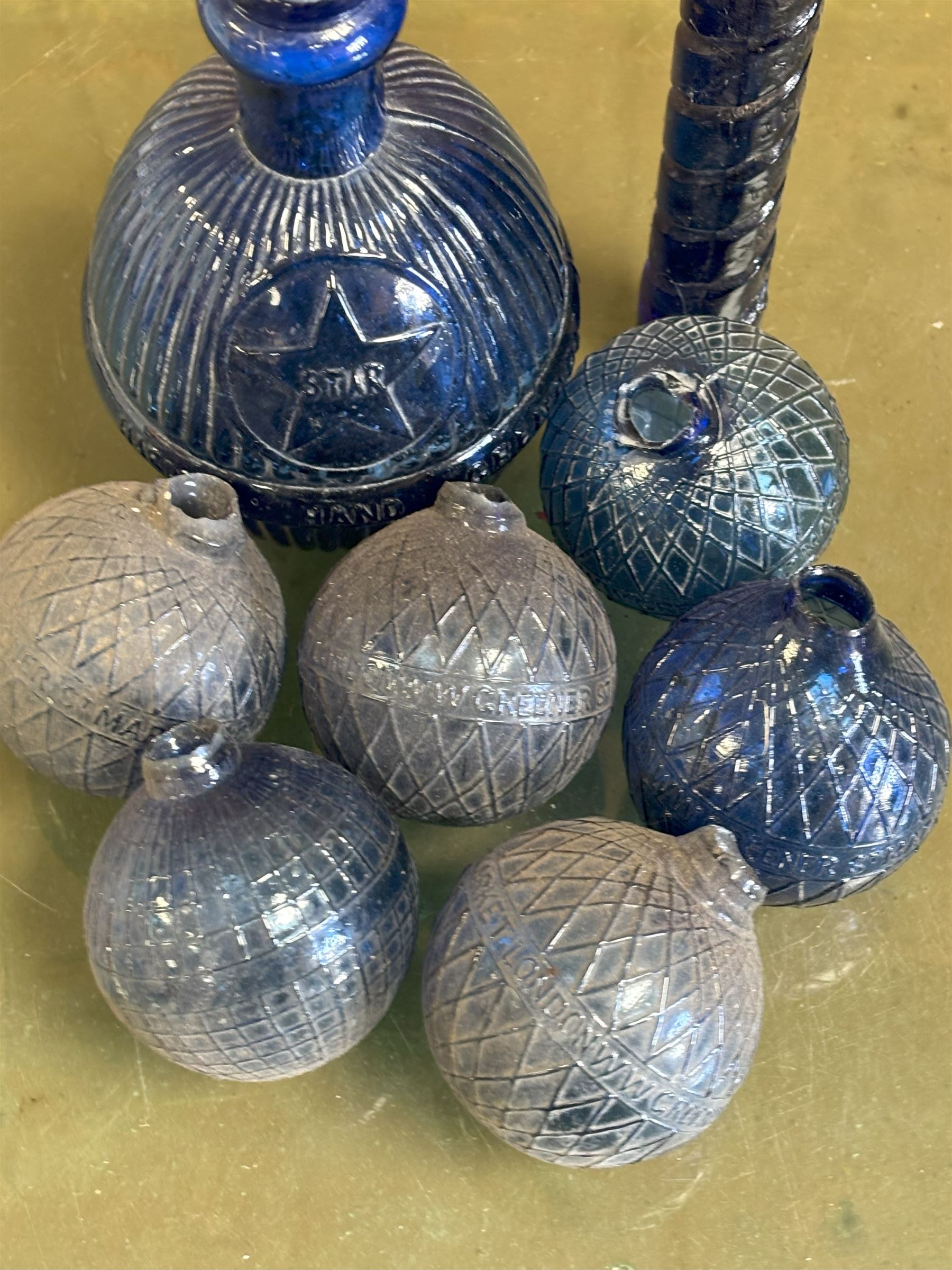 Collection of Victorian Bristol blue glass fire grenades, including an intact 'Star Hardens hand grenade fire extinguisher,' six smaller examples, some reading WW Greener, and a Minimax patent. (8) - COLLECTION BY APPOINTMENT FROM: The White House, Thirsk Road, Easingwold, York, YO61 3NF - CALL 01723 507111 TO ARRANGE