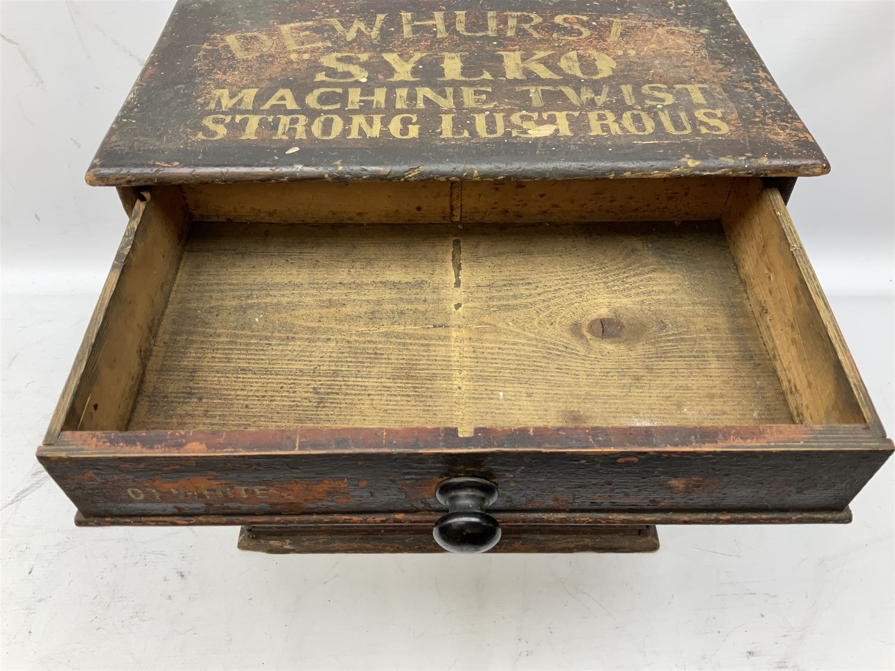 Early 20th Century Dewhurst table top chest, decorated with gilded 'Dewhurst's Sylko Machine Twist Strong Lustrous' lettering above six long drawers with names and numbers of cotton also detailed in gilt, H39cm