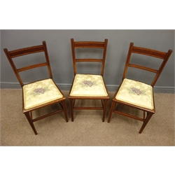  Set three Edwardian inlaid mahogany bedroom chairs, upholstered seat with floral pattern, square tapering supports joined by stretchers  