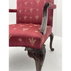 Pair Gainsborough style open armchairs, shaped arch cresting rail over scrolled and moulded arm supports carved with roundals and foliage, sprung serpentine seats, upholstered in red fabric decorated with repeating fleur-de-lis feathers and flower head motif pattern, acanthus carved cabriole supports with ball and claw feet
