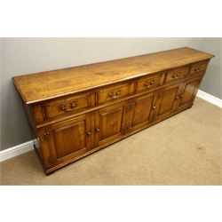  18th century style oak low dresser, with moulded top above five fielded front drawers and five raised and fielded panel doors with brass H shaped handles, on stile feet, W245cm, H87cm, D46cm  