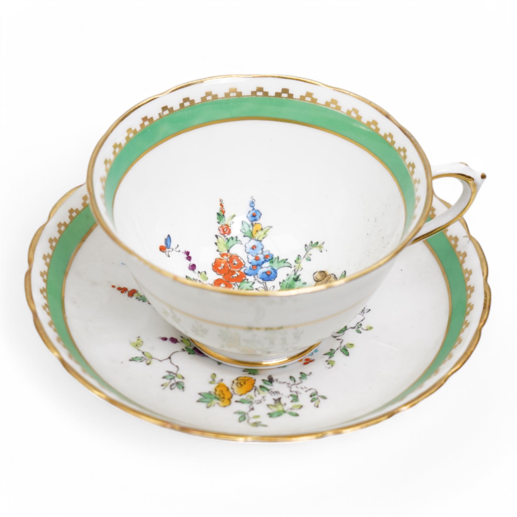 1930s Plant & Co Tuscan china tea set painted with flowers in blue, pink etc within a green border comprising twelve cups and saucers, twelve plates, two bread and butter plates, milk jug and sugar bowl (40)