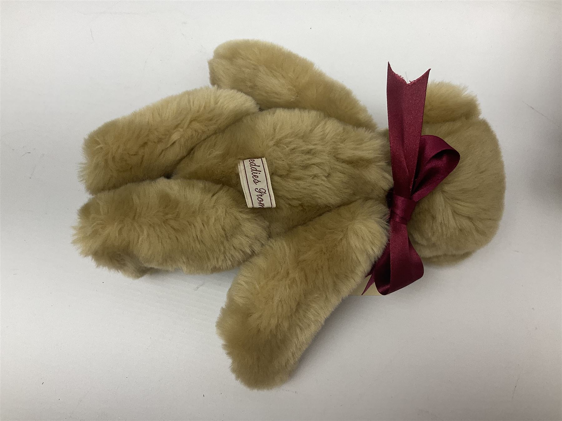 Group of five teddy bears comprising ‘George’ a unique pellet filled bear with glass eyes and velvet paws H38cm, and ‘Abbey’ a luxury German plush with wobble head and glass eyes no.5/10 H24cm, both with Teddies from Bearyland labels; along with two light blonde mohair H. M. Bears and Boyds Bears ‘T. F. Wuzzies’ no. 595140 (5)