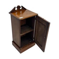 Victorian walnut bedroom suite - wardrobe, dressing chest and bedside cupboard, comprising a full-length wardrobe with broken pediment and central mirrored door, large lower drawer, a matching dressing table with bevelled swing mirror over two trinket drawers and two short drawers over two long drawers, and a single-door bedside cupboard, all with moulded edges, decorative panel work and shaped aprons