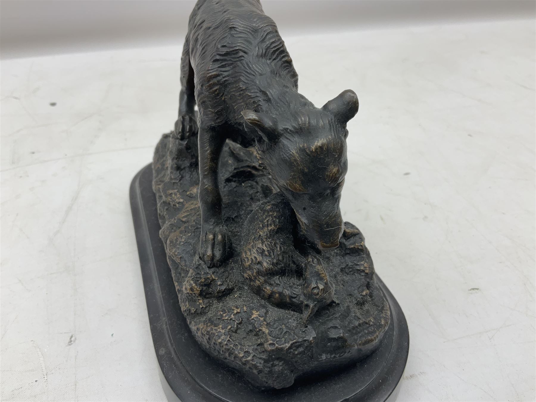 Bronze figure of a wolf with lamb prey, L18cm