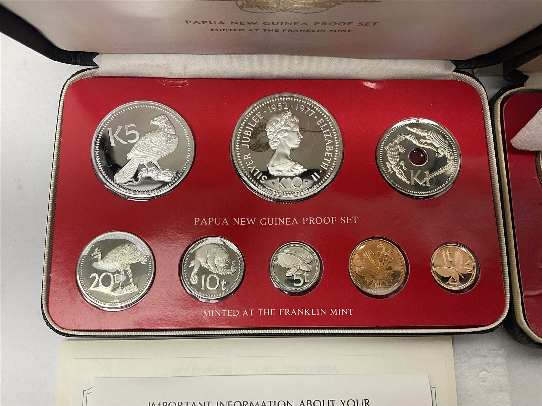 Four Papua New Guinea proof eight coin sets, from ten kina to one toea, comprising First Coinage of Papua New Guinea 1975 proof set, 1976, 1977, and 1979 proof sets, the 1977 and 1979 sets containing 925 silver ten kina and 500 silver five kina coins, all minted at the Franklin Mint, cased with certificates (4)
