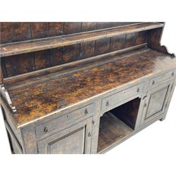 Bylaws of Leominster - 18th century design figured oak dog kennel dresser, the raised plate rack with projecting cornice over hooks and three tiers, moulded rectangular top over three drawers and two panelled cupboards, moulded frame and panelled sides, on stile supports