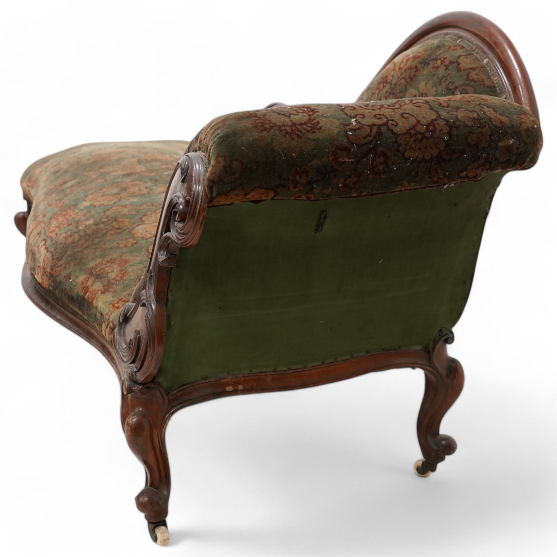 Mid-19th century mahogany chaise longue, shaped and rolled back carved and pierced with scrolling leaf decoration, upholstered in floral pattern fabric, on cabriole feet with brass and ceramic castors