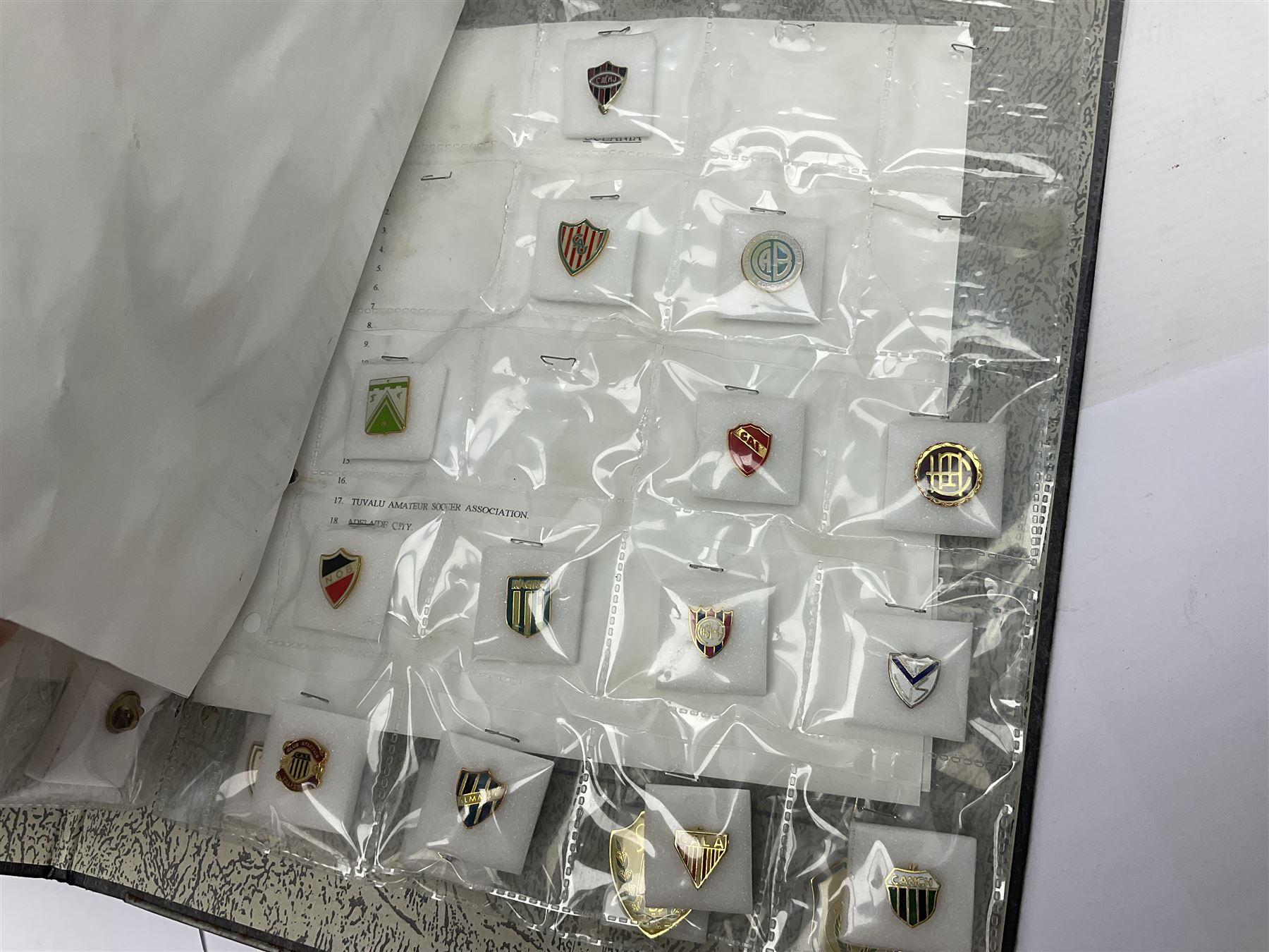 Large collection of approximately one hundred and eighty enamel badges and pins, relating to British and World football clubs, including loose examples and examples housed in folders, mostly identified