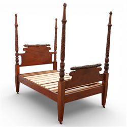 Early 19th century Regency carved mahogany four poster double bed, 4'6, the shaped headboard and footboard each surmounted by a finely carved pinecone and foliate moulded rail, flanked by ring turned and boldly spiral carved tapering posts with acorn finials, raised on square section legs, with slatted base