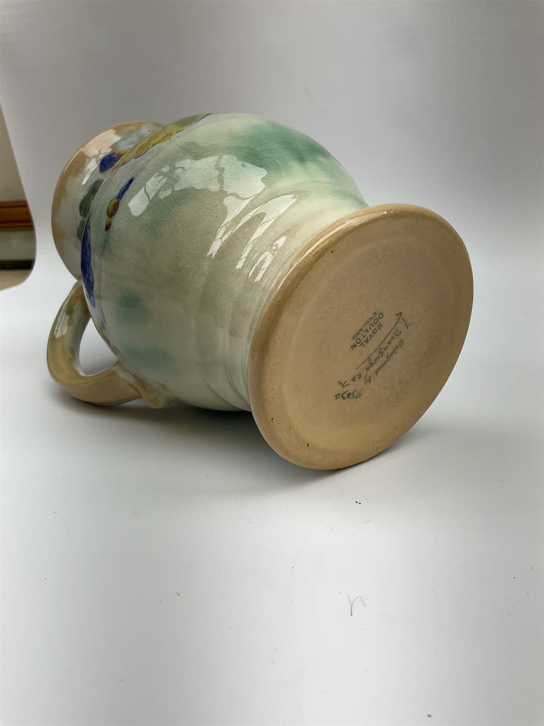 Early 20th century Royal Doulton Brangwyn Ware jug and set of six beakers, designed by Frank Brangwyn RA, all decorated in the Harvest pattern with stylised leaves and fruit on mottled peach and green ground, all with printed marks beneath, date code for 1920s, largest H18cm