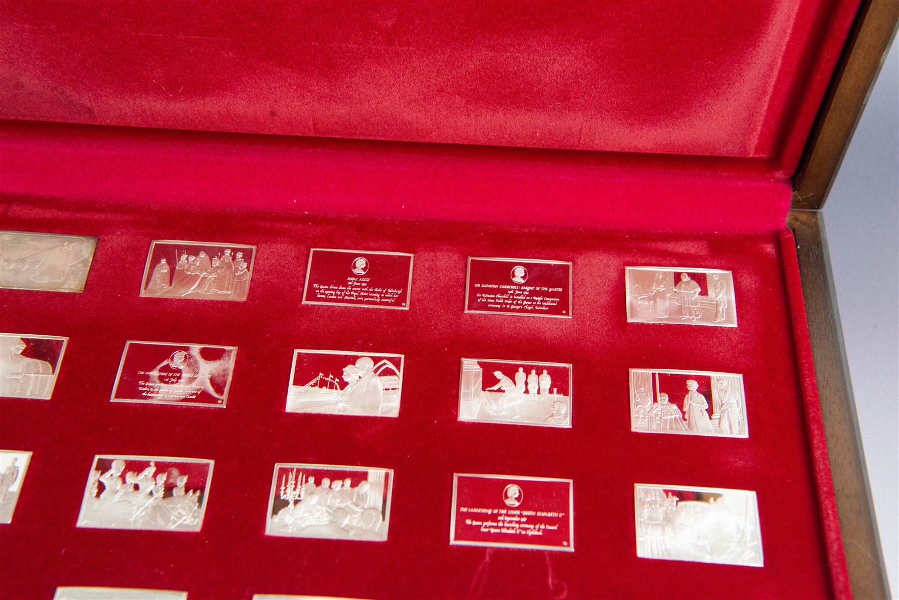 Elizabeth Our Queen silver ingots collection, twenty-five rectangular ingots each decorated in relief with a Royal scene, hallmarked John Pinches Ltd, London 1976, in wooden presentation case with information booklet