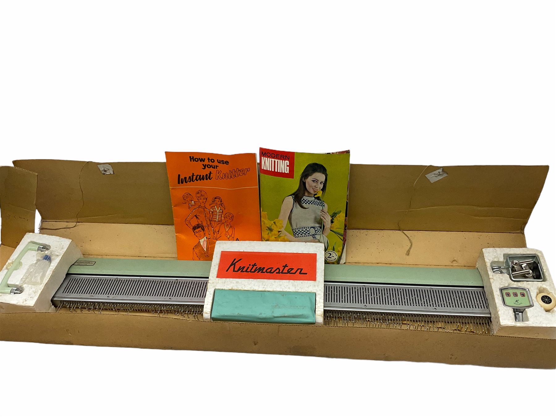Underwood manual typewriter with original cover and Knitmaster Knitting machine in original box with instructions. 