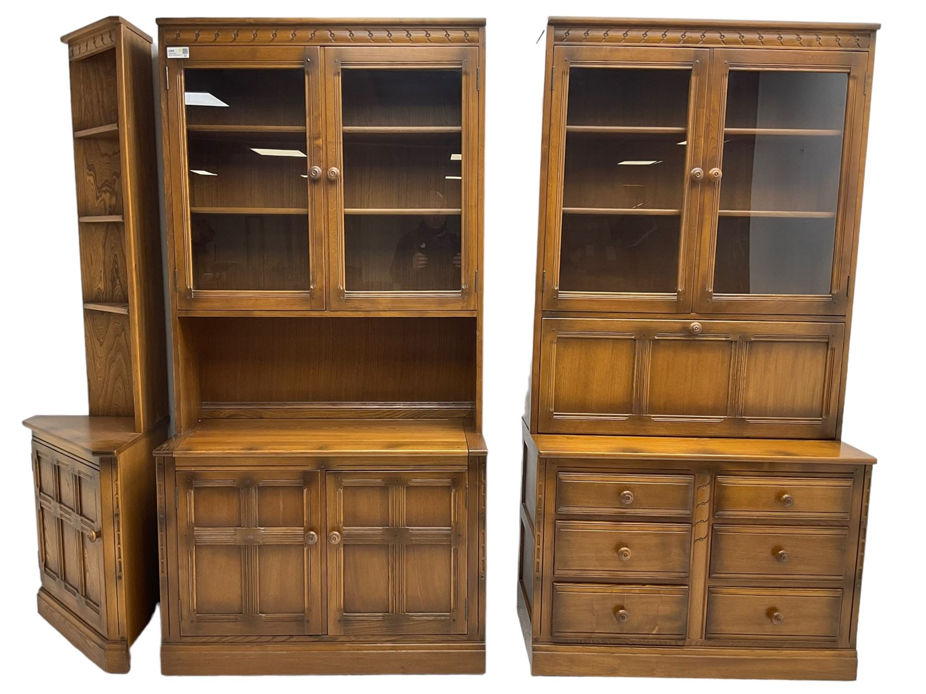 Ercol - mid-20th century dark elm 'Old Colonial' three sectional wall display unit, comprising two units and corner unit, fitted with open shelves, glazed cupboards and drawers