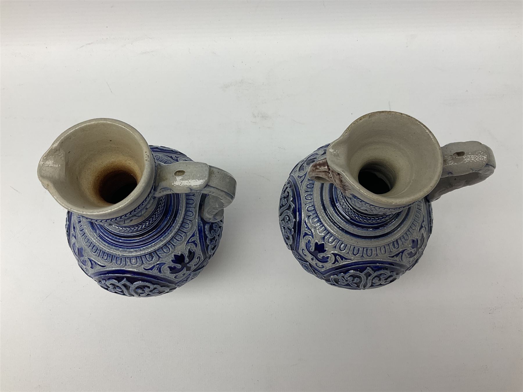Pair of late 19th Century German Simon Peter Gerz salt glaze stone jugs, impressed mark to base, model number 550, H15cm