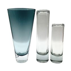 Two mid to late 20th Century Holmegaard vases by Per Lütken of cylindrical form with shaped upper rim, both engraved with 'Holmegaard' and monogram beneath, together with another blue art glass vase of tapering cone form (3)
